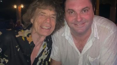 pic of jersey harmonica player Giles Robson with Mick Jagger when he performed in Mustique in feb 2024
