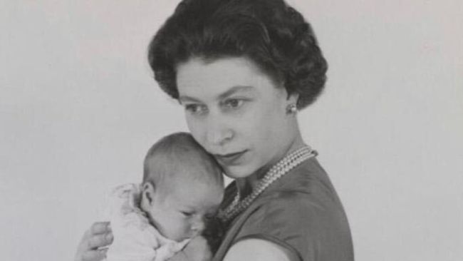 The Queen holding Prince Andrew as a baby.