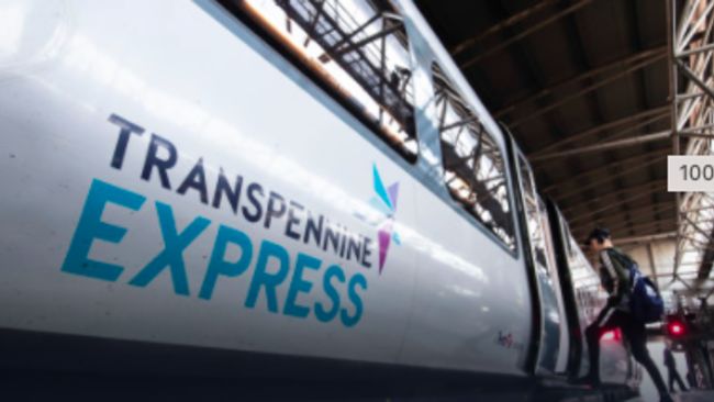 PASSENGER GETTING ON TRANSPENNINE EXPRESS TRAIN