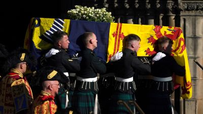 Pallbearers carry the coffin of Queen Elizabeth II as it departs St Giles' Cathedral, for Edinburgh Airport