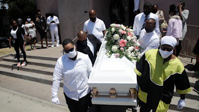 Pall bearers carry a Covid victim's coffin in LA