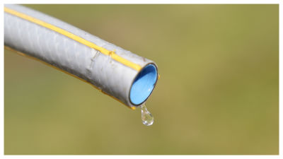 A drop of water falling from a hosepipe. 