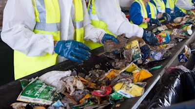 Volunteers sort waste at the recycling centre, at the Glastonbury Festival, at Worthy Farm in Somerset. All waste on site is sorted into recycling groups by volunteers working 5-hour shifts, in a process that will take up to three weeks to clean up the whole farm.