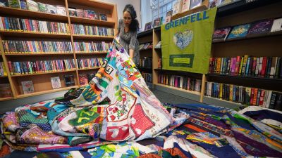 Artist Tuesday Greenidge, founder of the Grenfell Memorial Quilt Project, holding the work in progress