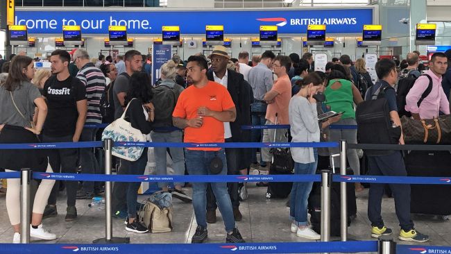 Queues in Terminal 5 at Heathrow airport, London. Receiving compensation for airline delays or cancellations should be like getting automatic reimbursement for similar train problems, the Transport Secretary has said. Speaking to the BBC's Sunday Morning programme, Grant S