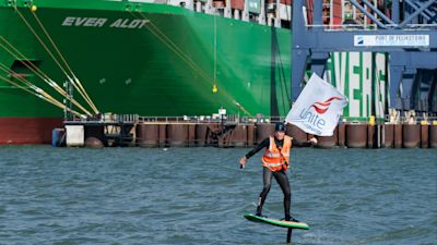 A man carrying a Unite the Union flag surfs around the Port of Felixstowe in Suffolk.
Credit: PA
