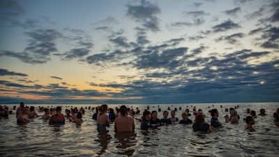 Picture of hundreds of people at Penarth Seafront taking part in world mental health day swim