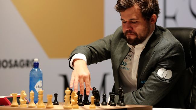 Norway's World Chess Champion Magnus Carlsen, makes a move in game five against Ian Nepomniachtchi of Russia, during the FIDE World Championship at the Dubai Expo, in Dubai, United Arab Emirates, Wednesday, Dec. 1, 2021. 