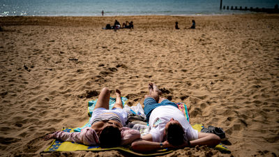 People enjoying the warm weather on Bournemouth beach.