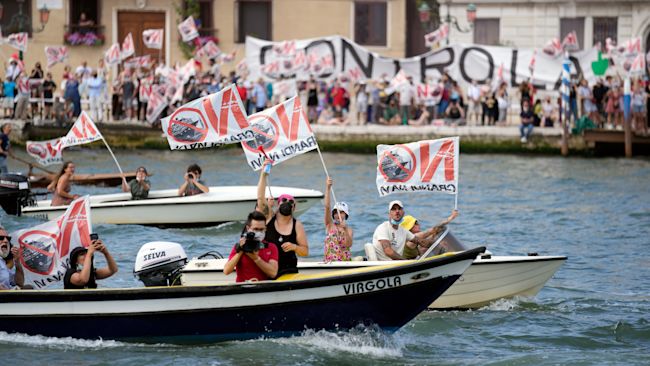 "No Big Ships" activists stage a protest as the MSC Orchestra cruise ship leaves Venice on Saturday.