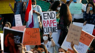 A woman holds an 'end rape culture' poster at a protest in Pakistan.