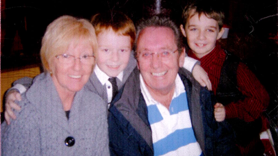 Brad pictured with his brother Aron, and his foster parents Eve and Frank.
