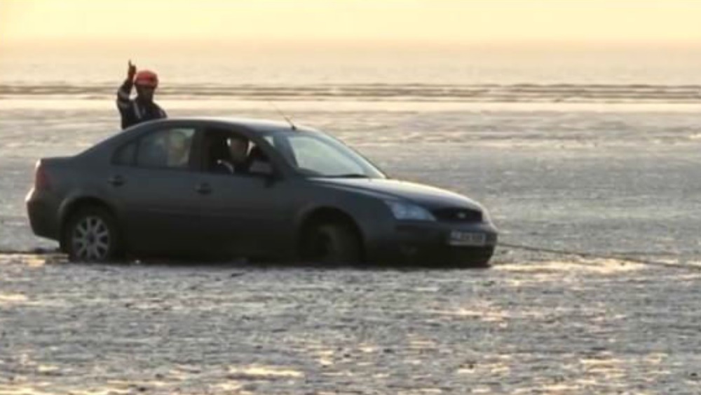 Family have to be rescued from beach after car gets stuck in soft sand ...