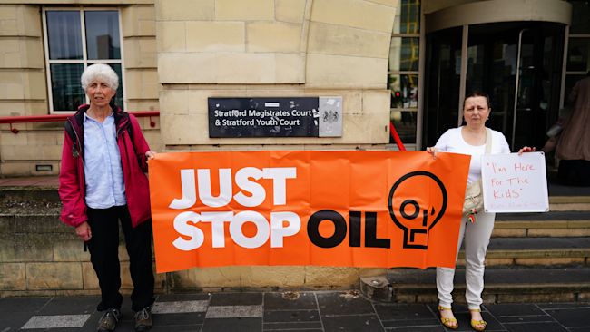 Just Stop Oil protesters Ben Plumpton (left) and Kate Bramfitt, arrive at Stratford Magis-trates' Court in east London, where they are charged along with Lora Johnson, Gregory Sculthorpe and Naomi Goddard with wilful obstruction of a highway, after they allegedly obstructed Parliament Street on November 6 last year.