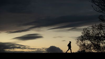 A man walks at sunset at Workington, in Cumbria.
PA