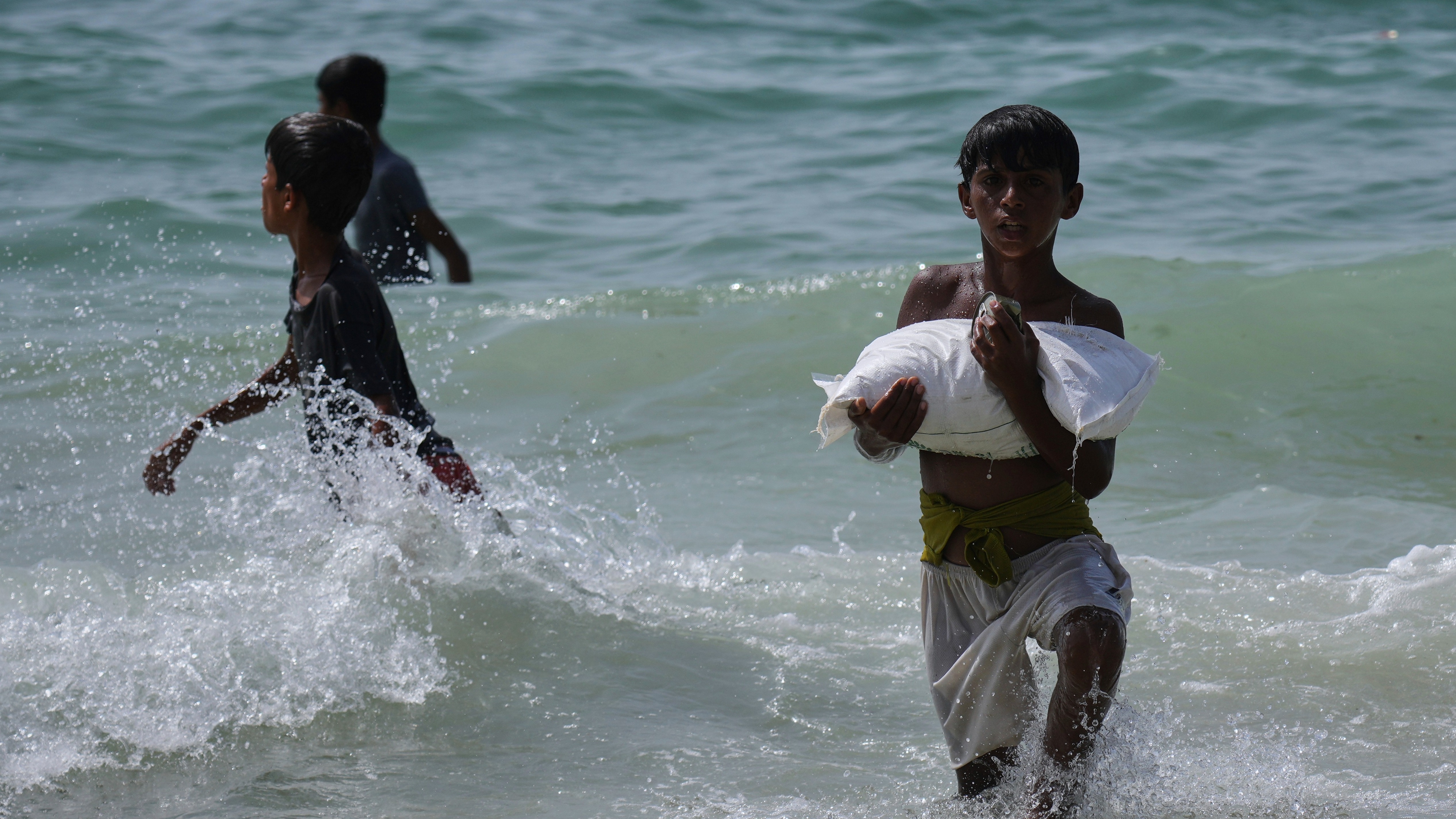 Gaza air drops: 'Chancing the waves' for a packet of biscuits