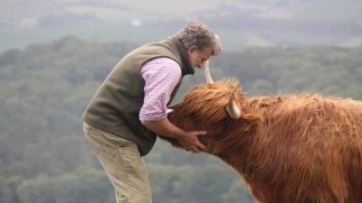 Cameron Farquharson with a highland cow