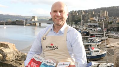 Ieuan Edwards with his products in hand with Conwy in the background
