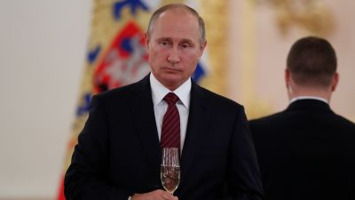 Russian President Vladimir Putin holds a glass of champagne during a ceremony of presenting ambassador's credentials in the Kremlin in Moscow, Russia, on Tuesday, Oct. 3, 2017.
