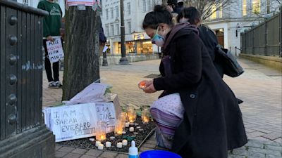A woman lights a candle in Birmingham after the Reclaim These Streets vigil for Sarah Everard was officially cancelled.