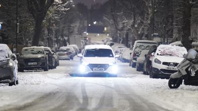 A car drives slowly along a snow covered road in the early morning at Willesden Green, north west London. Snow and ice have swept across parts of the UK, with cold wintry conditions set to continue for days. Picture date: Monday December 12, 2022.