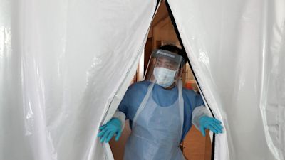 A member of hospital staff in PPE.