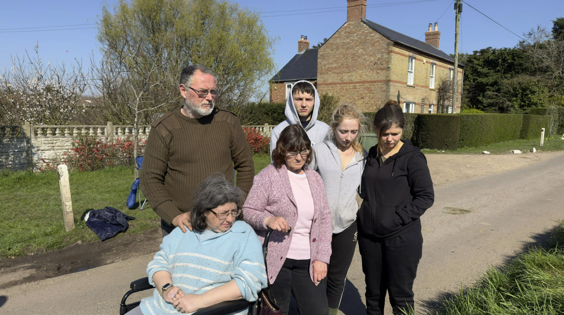 Parents and siblings gaze at the riverbank where Declan Berry's car entered the water