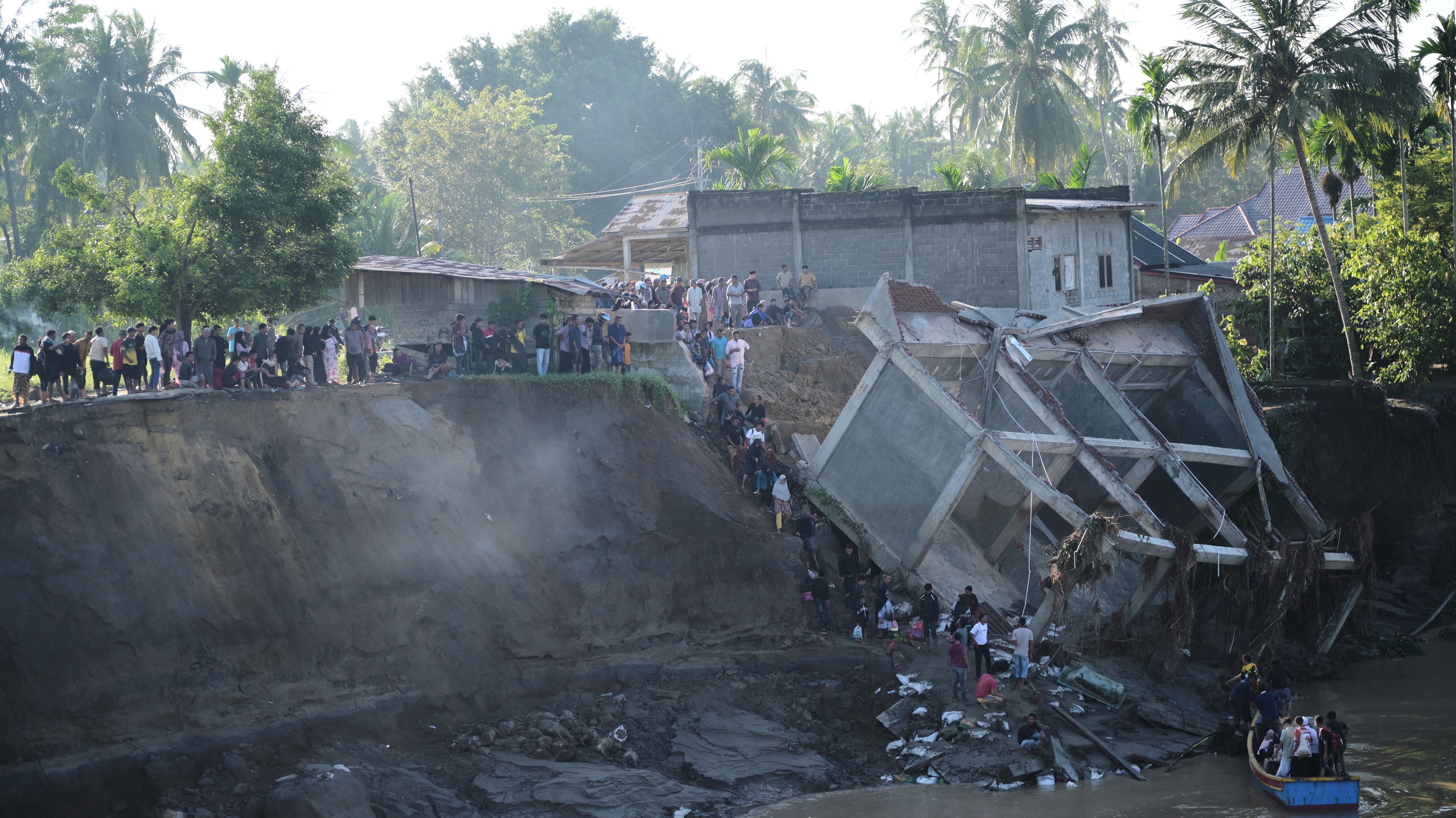 Landslides and floods triggered by cyclone kill at least 248 people in Indonesia