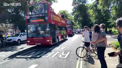 Crowds cheer Harrogate Town players celebrating first time in Football League open top bus