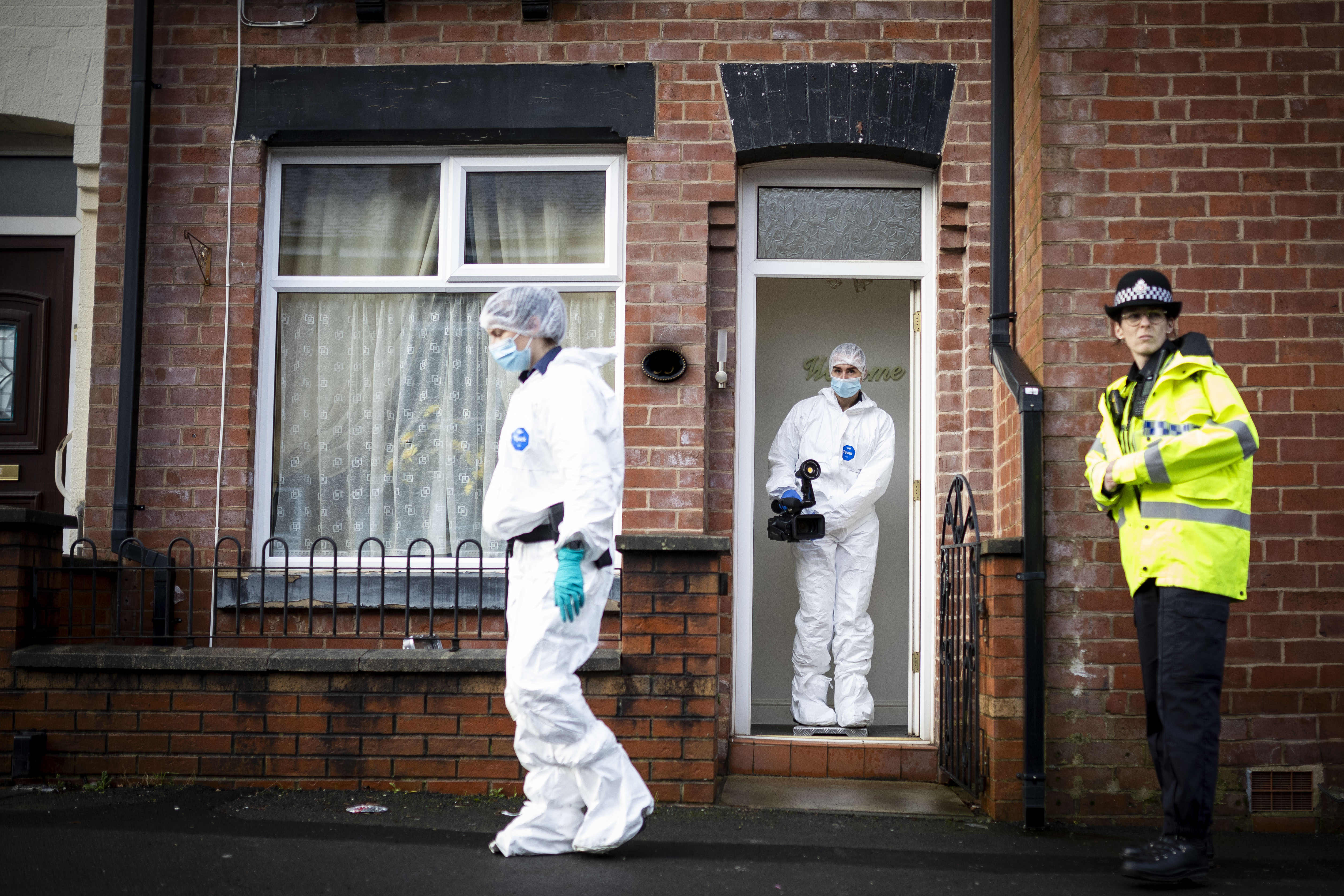 Forensic investigators were pictured entering and leaving as searches of the property were continuing on Christmas Eve.