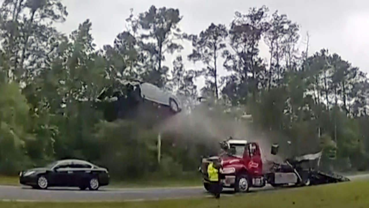 Watch as car is propelled into air after riding up tow truck ramp in US