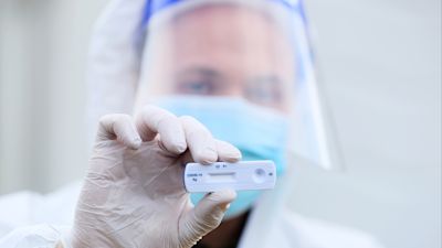 A lab technician holds a Healgen Covid-19 Rapid Antigen Test at RocDoc's testing facility in Gorey, Co. Wexford, for lorry drivers bound for France.