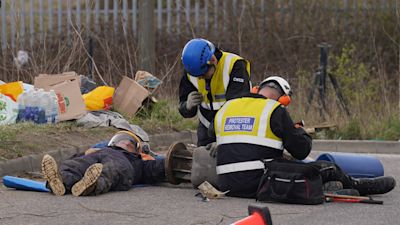 Police officers from the Protester Removal Team work to free a Just Stop Oil activist who is part of a blockade at the Tritan Truck Park in Grays, Essex. Activists from Just Stop Oil have blocked access to the Titan Truck Park and revealed a secret underground network of tunnels at the Navigator and Grays oil terminals. Picture date: Saturday April 2, 2022.