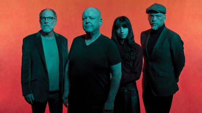 Pixies four band members standing by orange background