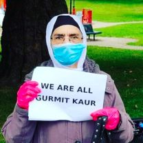 Gurmit Kaur holds up a sign sign saying "We are all Gurmit Kaur"