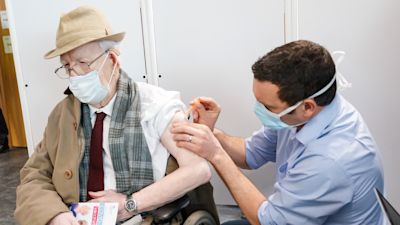 Frederick Durber receives the Oxford/AstraZeneca coronavirus vaccine, admininstered by Chief Pharmacist Richard Harrison, at Askham Bar park-and-ride in York, as ten further mass vaccination centres opened in England with more than a million over-80s invited to receive their coronavirus jab.