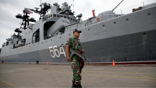 A member of the Indonesian military stands guard near the Russian Navy anti-submarine destroyer, "Admiral Tributs" at Tanjung Priok Port in Jakarta.