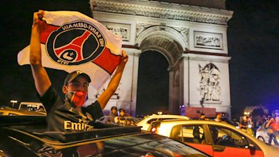 A PSG fan celebrates the club's Champions League semi-final win over RB Leipzig.