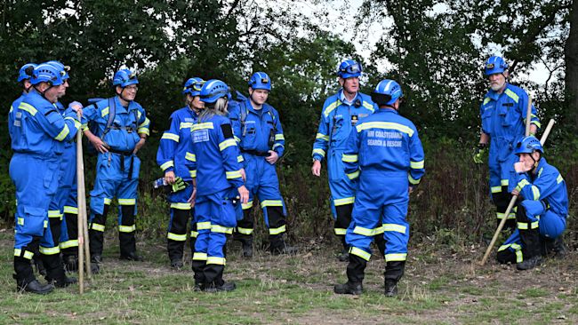A team from the coastguard standing in a field during a search for missing toddler Noah Woods.