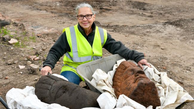 Carolyn Veit, a volunteer at the Roman dig in Carlisle, with the two Roman heads found on the site. Picture: Stuart Walker Photography.