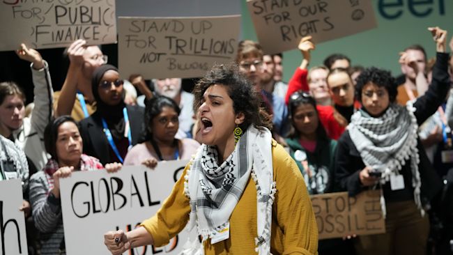Activists participate in a demonstration for climate finance at the COP29. AP