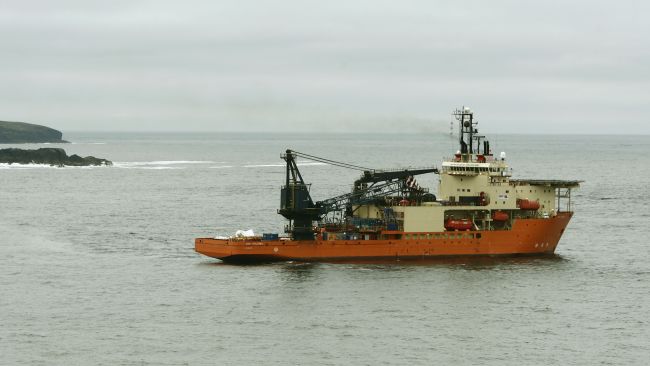 Dive Vessel Bibby Polaris, that was involved in the salvage of a Super Puma helicopter that plunged into the North Sea killing four oil workers, is pictured off the coast of Shetland. A white tarpaulin covers material towards the rear of the vessel.
