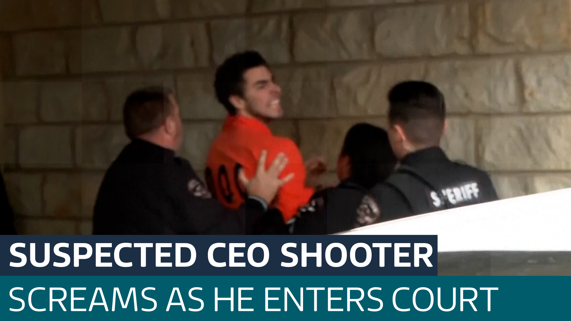 Man charged with killing CEO screams at cameras as he's taken into ...
