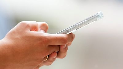 PERSON'S HANDS AND A PHONE