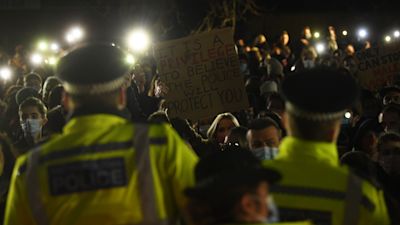 A woman holds up a placard as people gather in Clapham Common, London, after the Reclaim These Streets vigil for Sarah Everard was officially cancelled. Serving police constable Wayne Couzens, 48, has appeared in court charged with kidnapping and killing the marketing executive, who went missing while walking home from a friend's flat in south London on March 3. Picture date: Saturday March 13, 2021.
