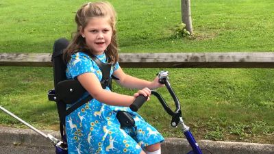 Picture of disabled 8-year-old Isabella on her adapted bicycle