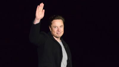 Elon Musk waves while providing an update on Starship, on Feb. 10, 2022