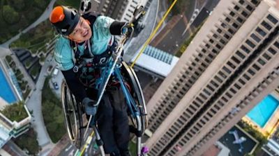 37-year-old paraplegic athlete Lai Chi-Wai scaling the Nina Tower in Hong Kong