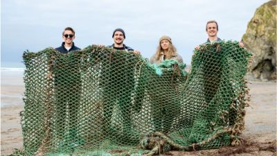 25-01-22 -Group holding large trawler net on Tolcarne beach in Newquay-Waterhaul