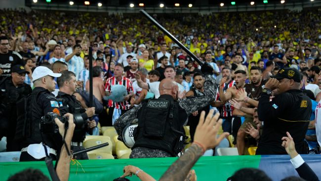 Police clash with fans at the Maracana stadium.